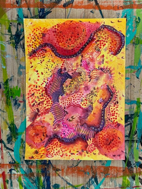 Abstract mixed-media painting with layers of warm red, yellow, and pink washes, dark curved lines, and scattered dot patterns that create rhythm and depth.