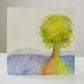 Artistic depiction of a tree with a colorful landscape in the background